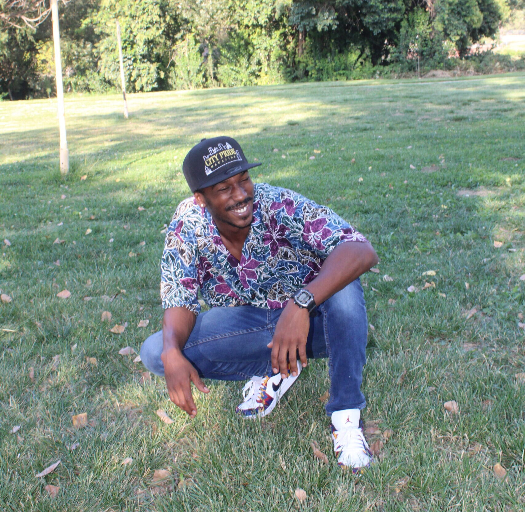 Emon Johnson smiling while on grass